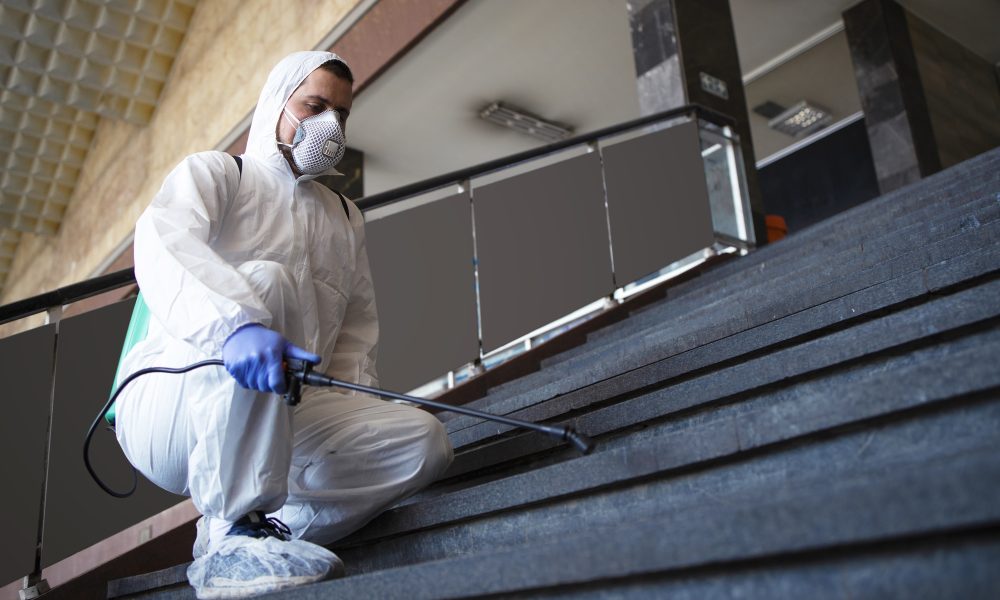 person-white-chemical-protection-suit-disinfecting-public-corridors-steps-stop-spreading-highly-contagious-corona-virus